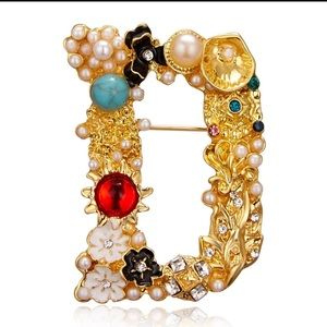 Beautiful ornate letter brooch